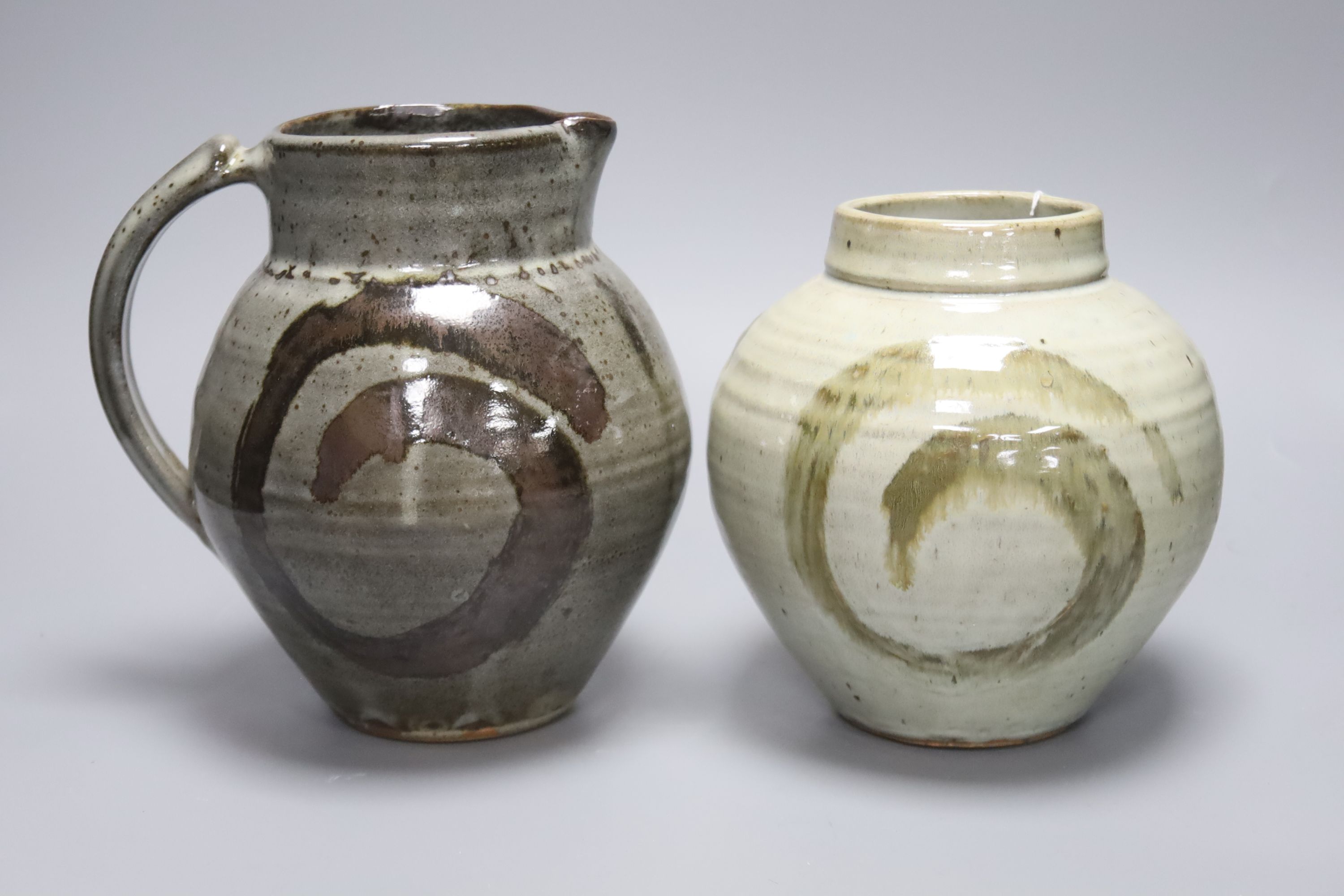 Clare Sutcliffe. A pottery jug and a similar vase, tallest 22cm